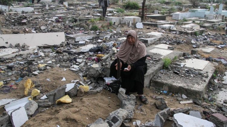 Palestinian visits graves of those killed in ongoing conflict