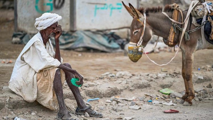 An old Sudanese man waits to fill his water tank pulled by a donkey in Port Sudan