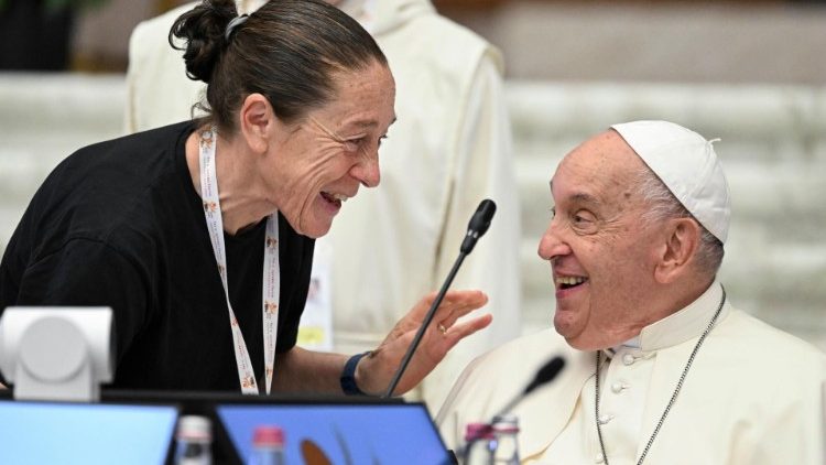 Pope Francis greets one of the participants in the Synod